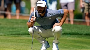 Mar 12, 2021; Ponte Vedra Beach, Florida, USA; Dustin Johnson lines up his putt on the seventh green during the second round of The Players Championship golf tournament at TPC Sawgrass - Stadium Course.